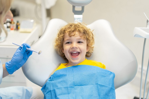 cute-young-boy-visiting-dentist-having-his-teeth-checked-by-female-dentist-dental-office.jpg